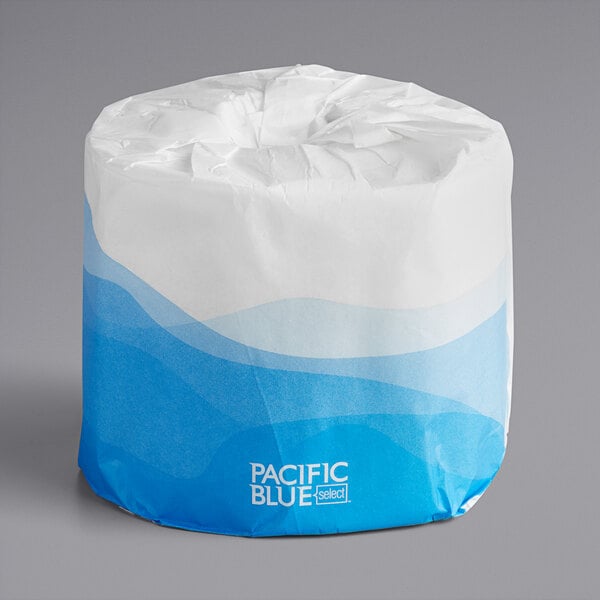 A white paper bag with a blue and white wave design on it.