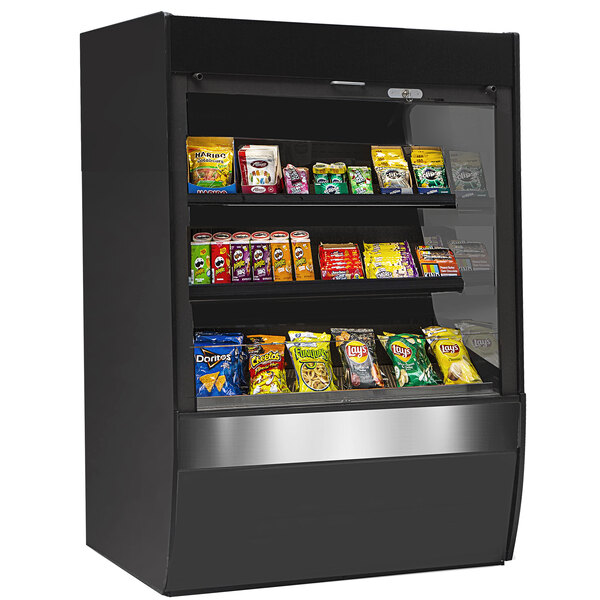 A black display case with different types of snacks on shelves.