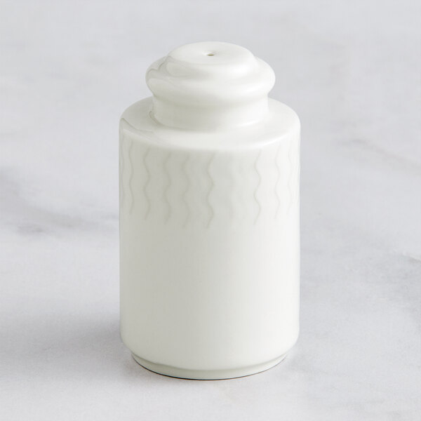 A RAK Porcelain ivory pepper shaker on a white surface.