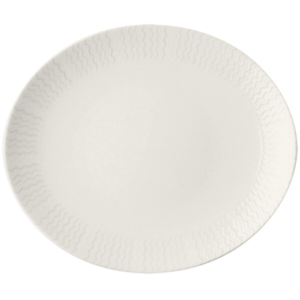 An ivory RAK Porcelain oval plate with a pattern of wavy lines.