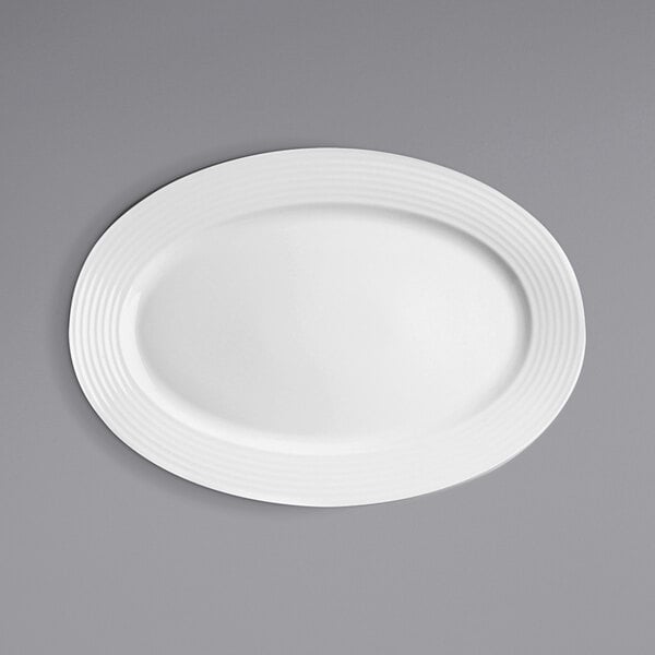 A white RAK Porcelain oval plate on a gray surface.