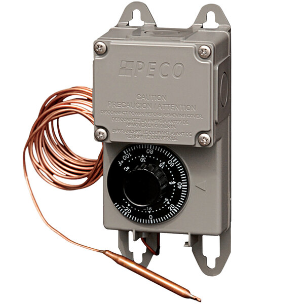 A close-up of a grey PECO commercial thermostat with a dial and a copper wire.