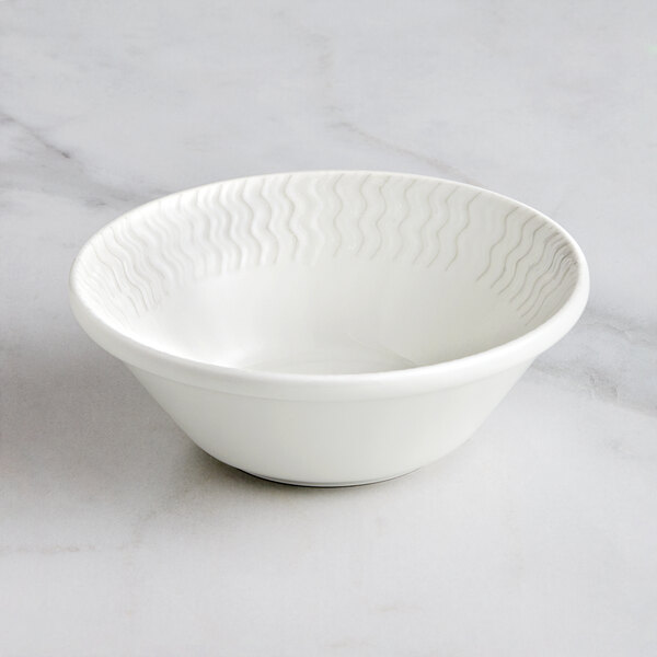 A RAK Porcelain ivory porcelain bowl with wavy lines on it.