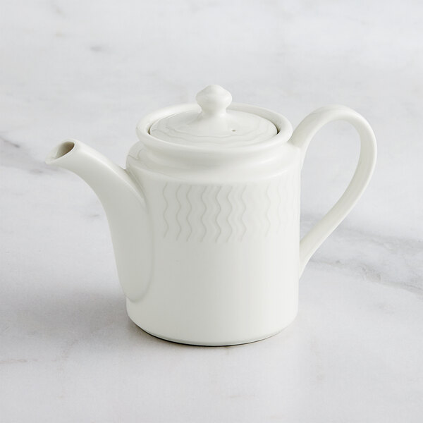 A RAK Porcelain white teapot with lid on a marble surface.