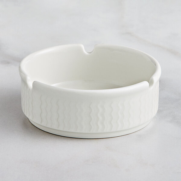 A white RAK Porcelain Leon ashtray with a pattern on it.