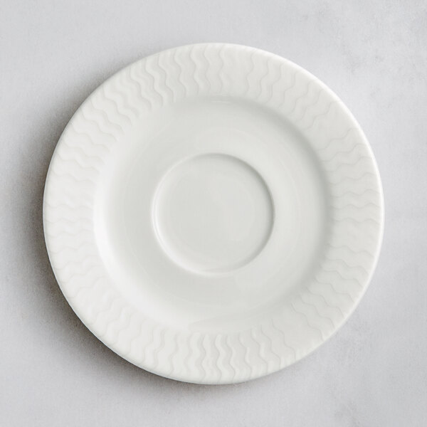 A white RAK Porcelain saucer with a circular pattern.