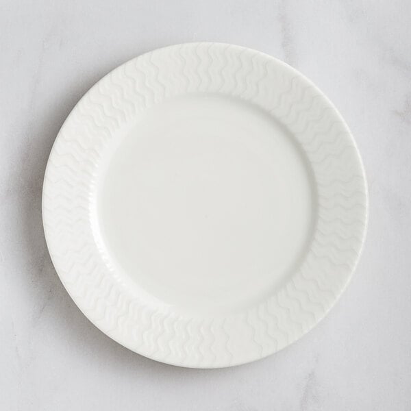 A RAK Porcelain ivory flat plate with an embossed wavy design.