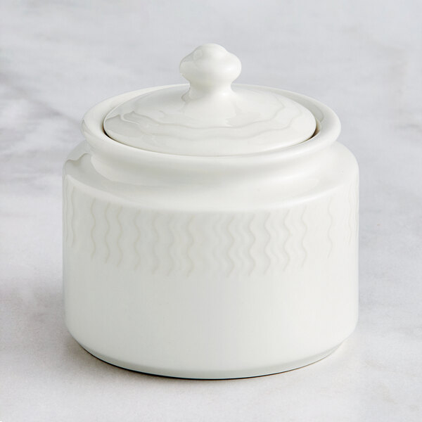 A RAK Porcelain ivory embossed porcelain sugar bowl with a lid.