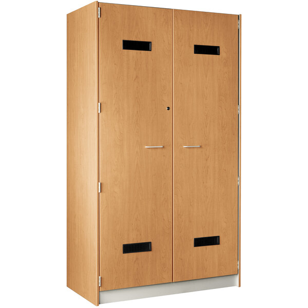 A wooden locker with two doors and a maple finish.