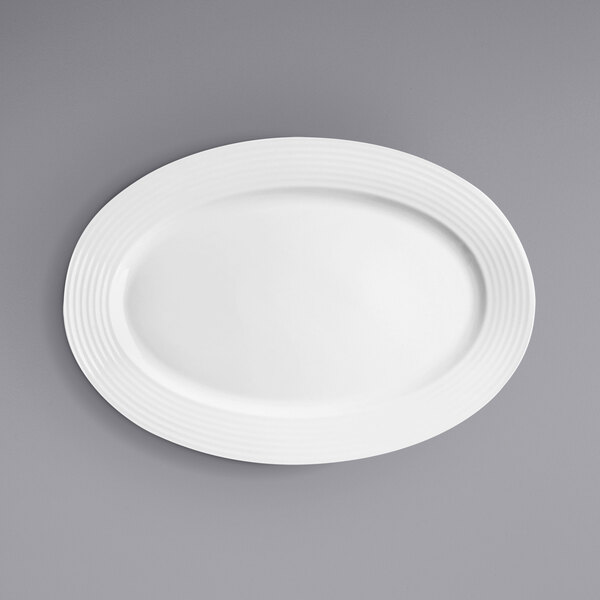 A white oval plate on a gray surface.