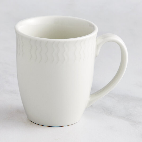 A white RAK Porcelain Leon coffee mug with an embossed design of waves.