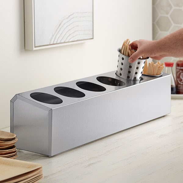 A person using a Choice stainless steel flatware organizer to put food away.