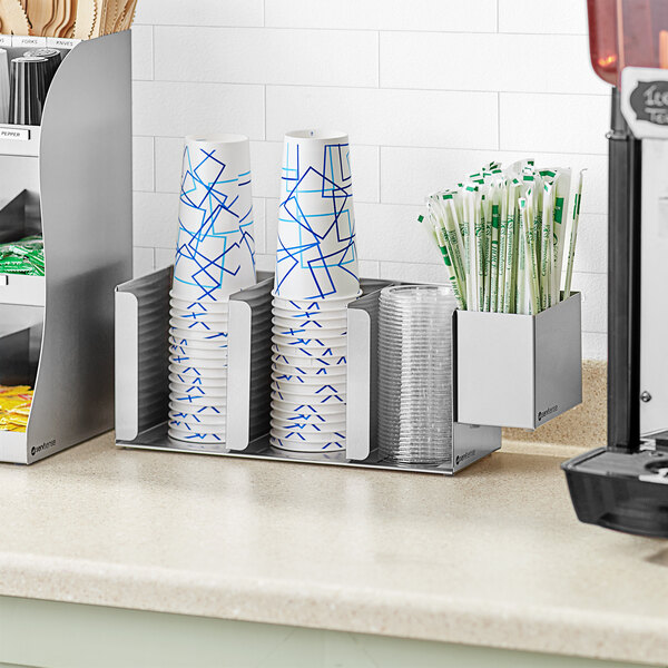 A ServSense stainless steel countertop cup and lid holder with straw caddy attachment holding cups and straws.