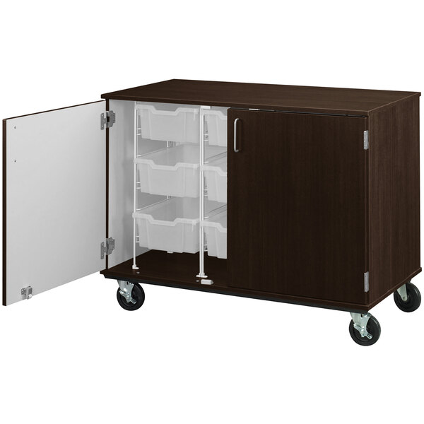 A brown I.D. Systems mobile storage cabinet with white drawers.
