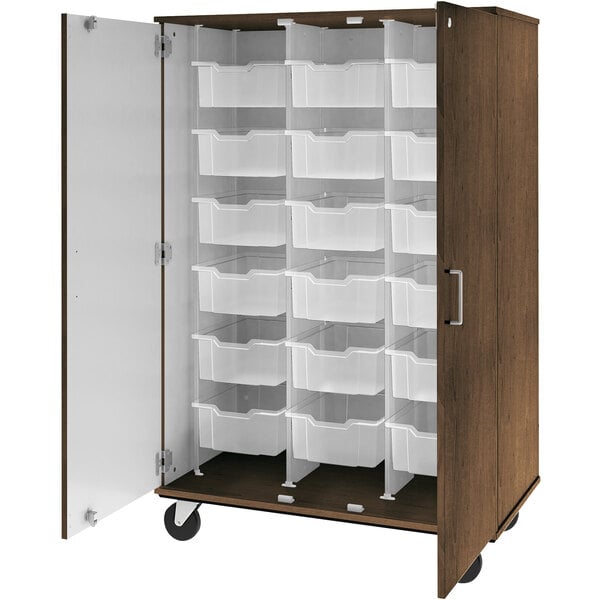 A dark walnut I.D. Systems mobile storage cabinet with many bins inside.