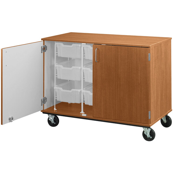 A medium cherry wooden mobile storage cabinet with open door showing 9 bins inside.