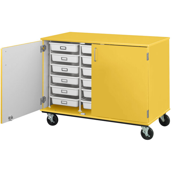 A sun yellow I.D. Systems mobile storage cabinet with open doors and trays inside.