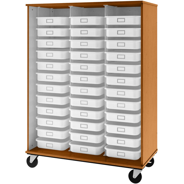 A tall light oak storage cabinet with white plastic bins on shelves.