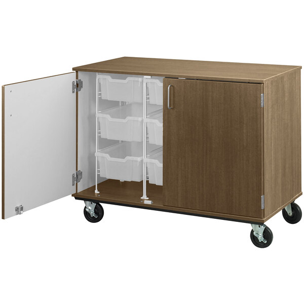 A brown I.D. Systems mobile storage cabinet with white bins on wheels.
