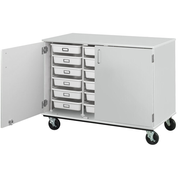 An I.D. Systems white mobile storage cabinet with open drawers.