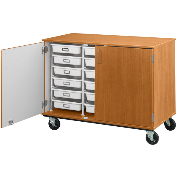 A light oak I.D. Systems mobile storage cabinet with open drawers and a door.
