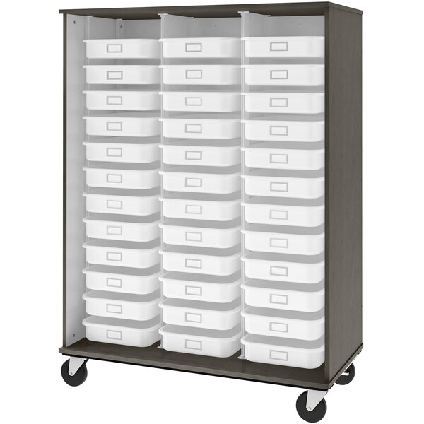 A dark wood mobile storage cabinet with white plastic bins on shelves.