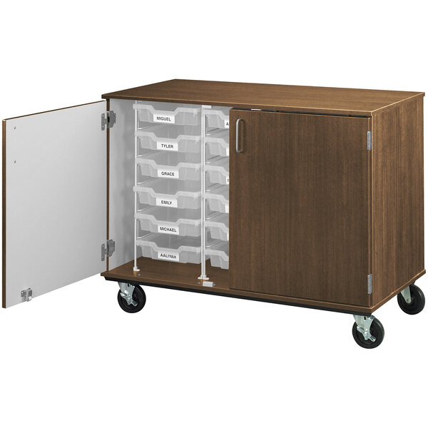 A dark walnut I.D. Systems mobile storage cabinet with drawers and wheels.