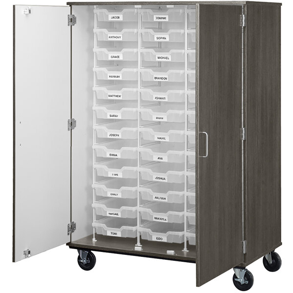 An I.D. Systems tall dark elm storage cabinet with many bins inside.
