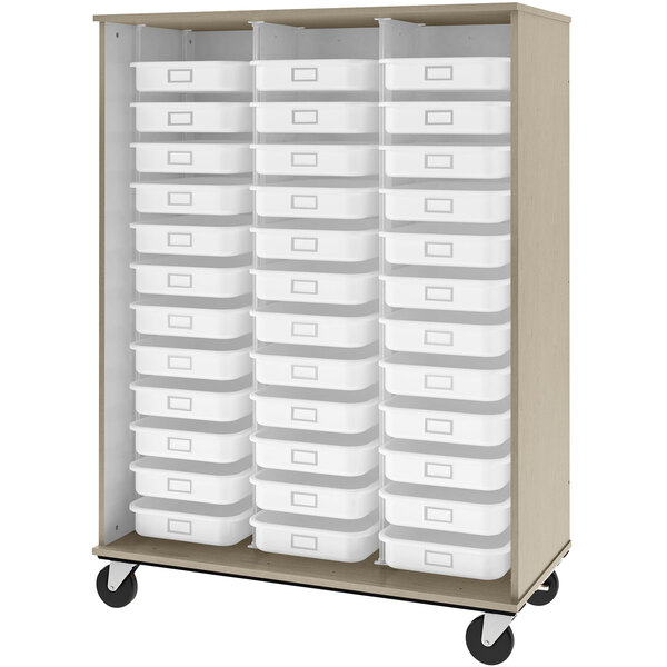 A natural wood storage cabinet with white plastic bins on shelves.