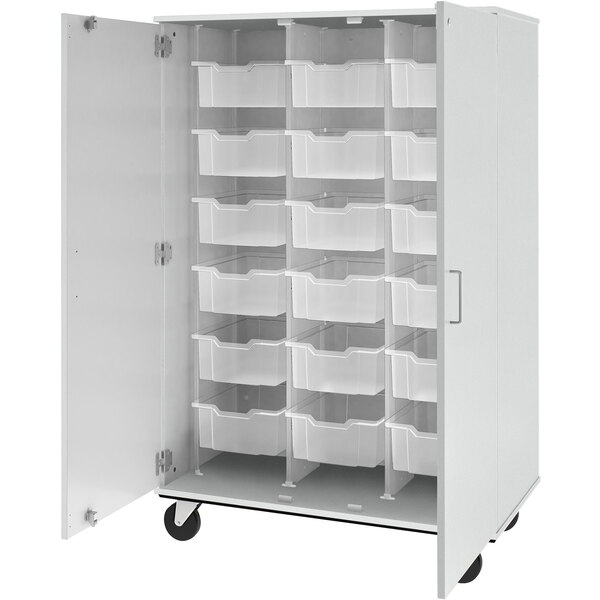 A white I.D. Systems storage cabinet with plastic bins inside.