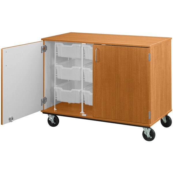 A light oak I.D. Systems mobile storage cabinet with open door and bins inside.
