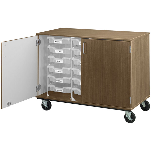 A Roman walnut I.D. Systems mobile storage cabinet with drawers on wheels.