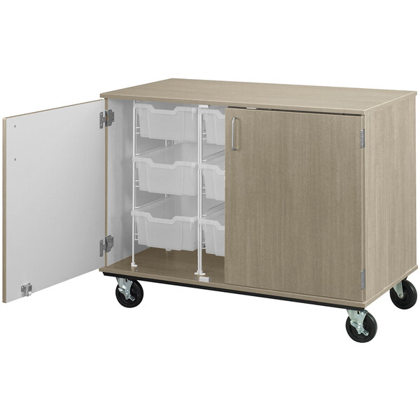 A natural elm I.D. Systems mobile storage cabinet with open doors revealing bins on wheels.