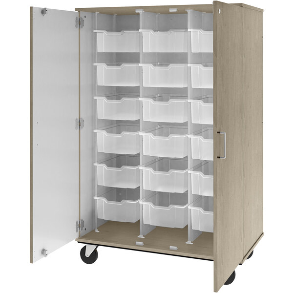 A white I.D. Systems mobile storage cabinet with many white plastic bins inside.