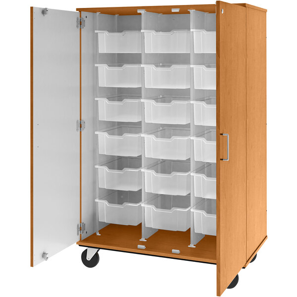 A light oak I.D. Systems mobile storage cabinet with white bins inside.
