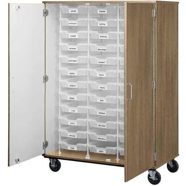 A large wooden I.D. Systems mobile storage cabinet with drawers and wheels.
