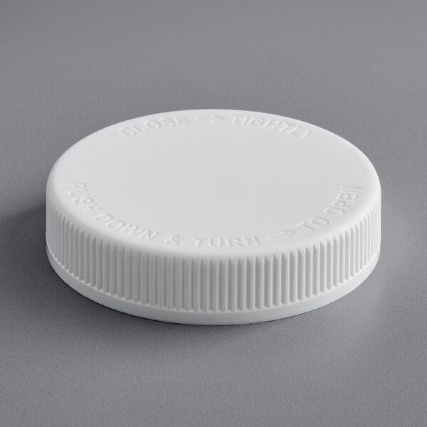A white plastic 70/400 child-resistant cap with text on it.