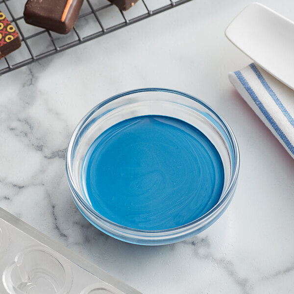 A bowl of blue liquid cocoa butter.