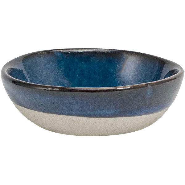 A Front of the House indigo and white porcelain ramekin with a black rim.