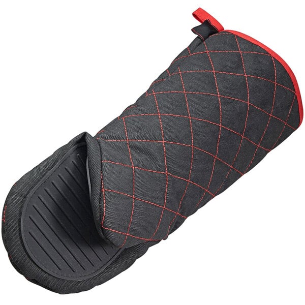 A black neoprene oven mitt with red stitching.