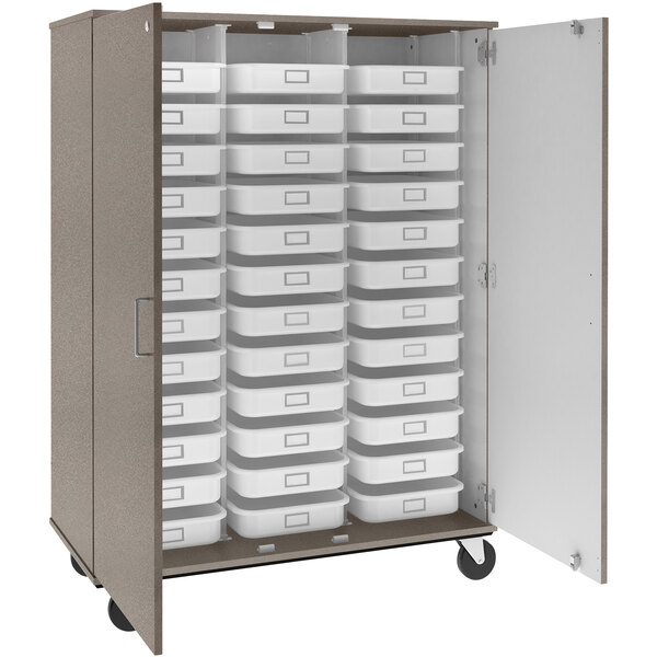 A grey I.D. Systems mobile storage cabinet with many trays inside.
