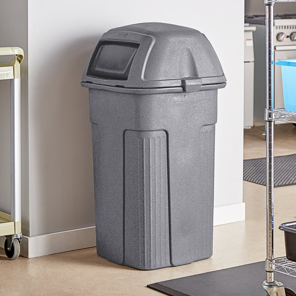 A Toter gray square trash can with square dome lid in a room.