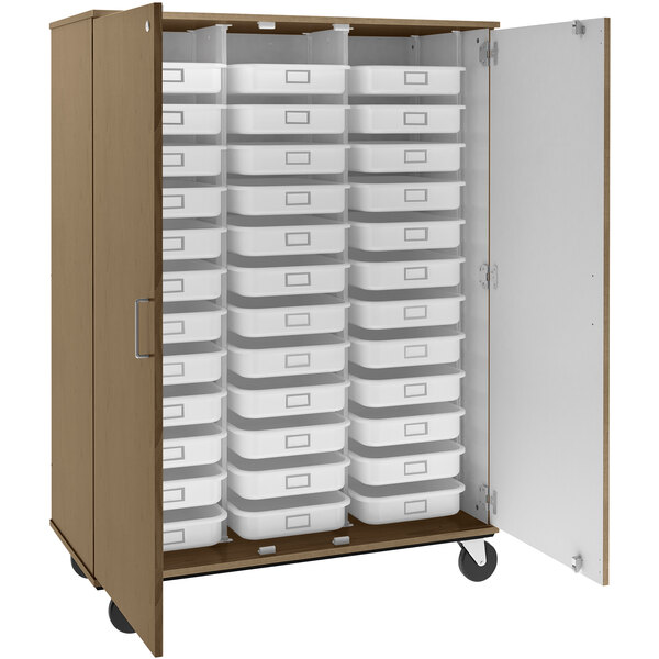 A Roman walnut I.D. Systems mobile storage cabinet with many trays inside.