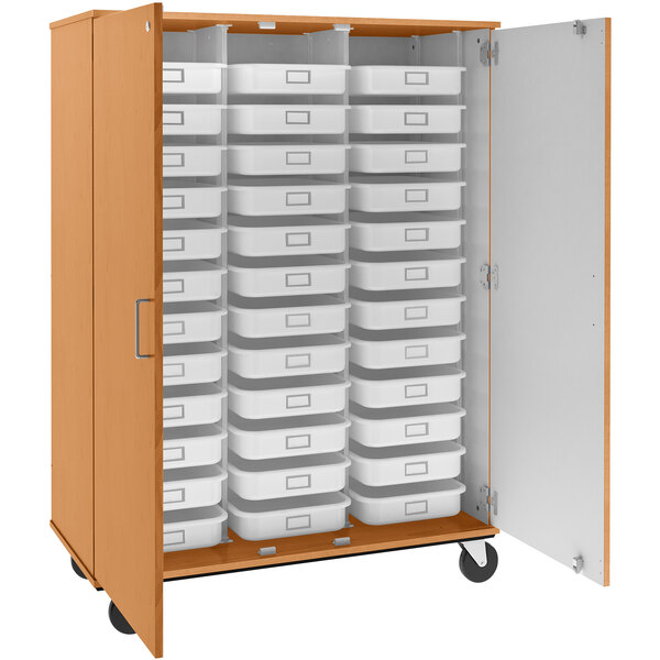 A light oak I.D. Systems mobile storage cabinet with trays on the shelves.