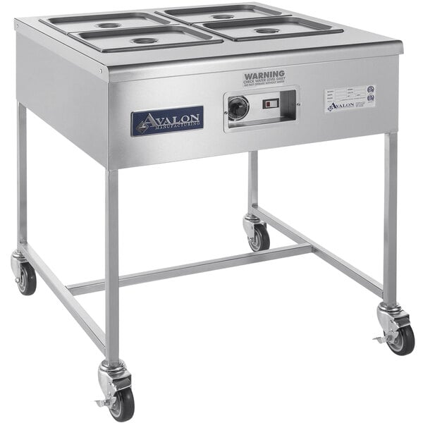 A stainless steel Avalon Manufacturing hot icing station with (4) 8 quart pans.