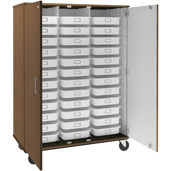 A dark brown I.D. Systems mobile storage cabinet with many trays inside.