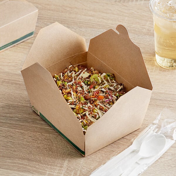A Kraft EcoChoice take-out container on a table with a white plastic spoon and fork.