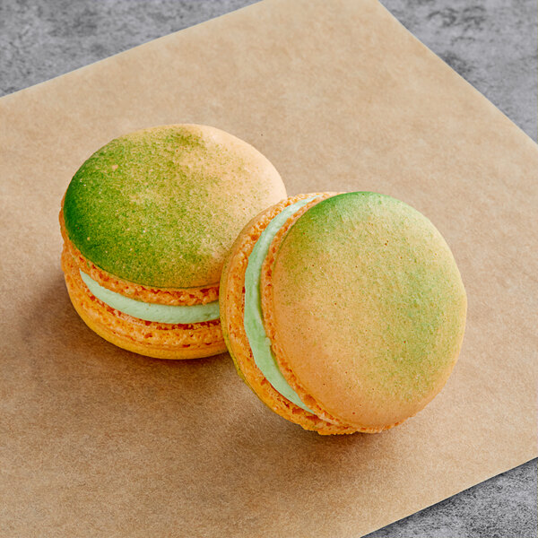 A close up of a green and yellow Macaron Centrale sitting on a piece of paper.
