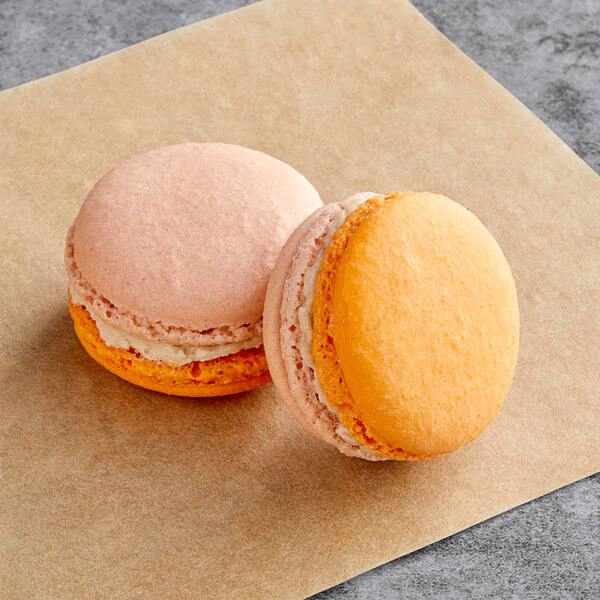 Two Macaron Centrale Chai Latte macarons on brown paper.