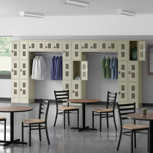 A room with tables and chairs and Regency beige lockers.